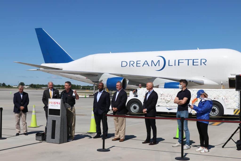 Boeing dreamlifter on the ramp at GSP airport with executives giving remarks